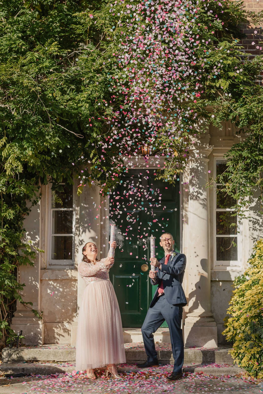 bride and groom in confetti canon at morden park house wedding