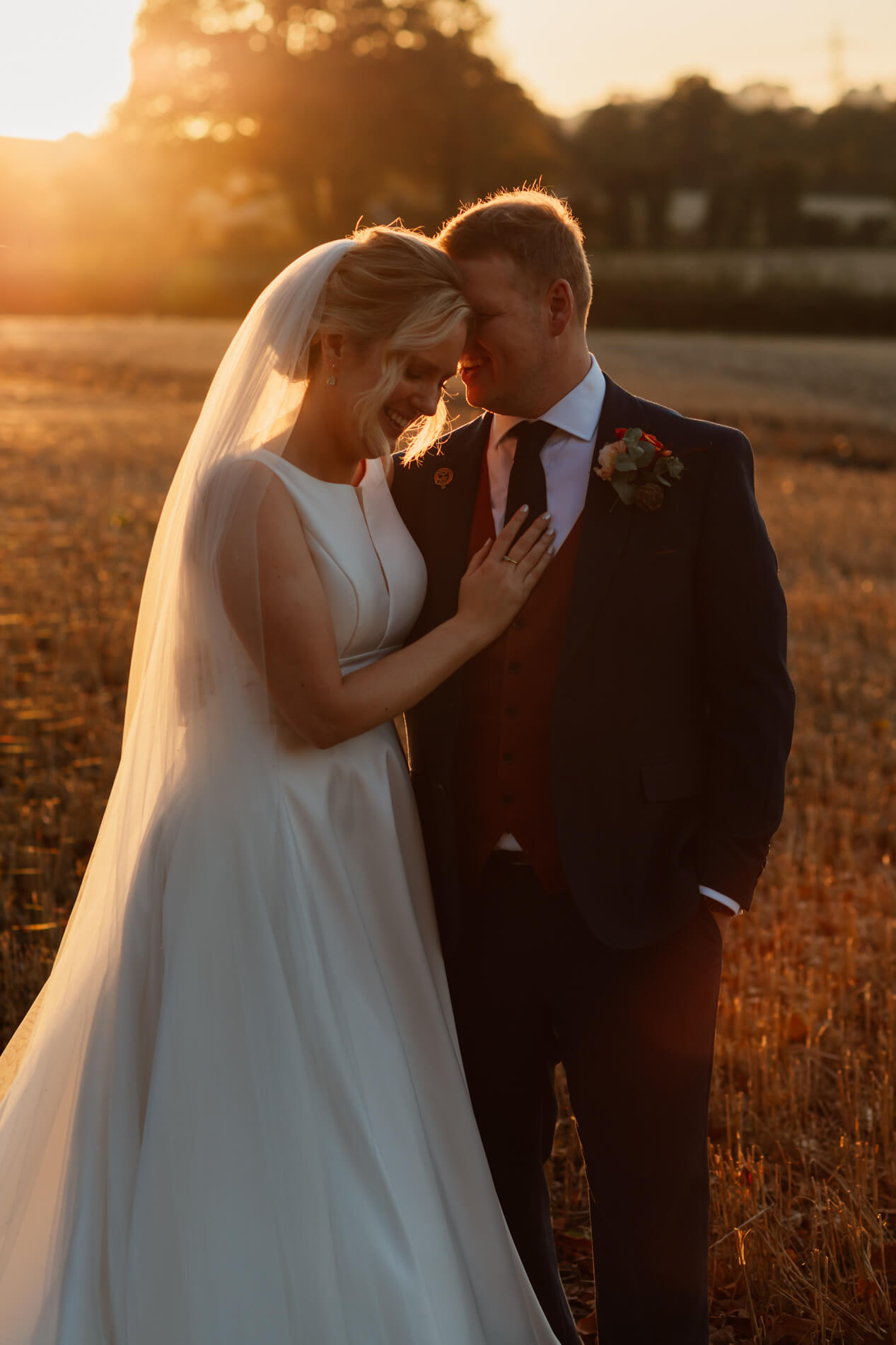 bride and groom in the sun set