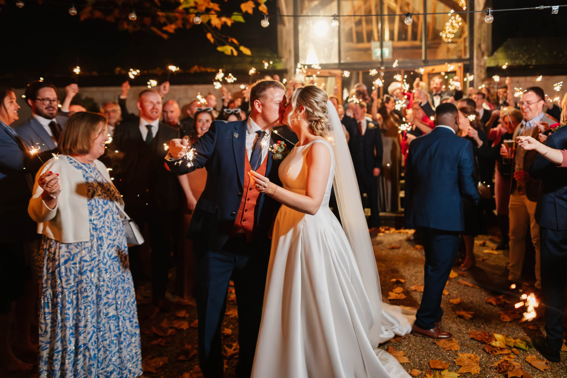 couple kissing in the middle of sparklers