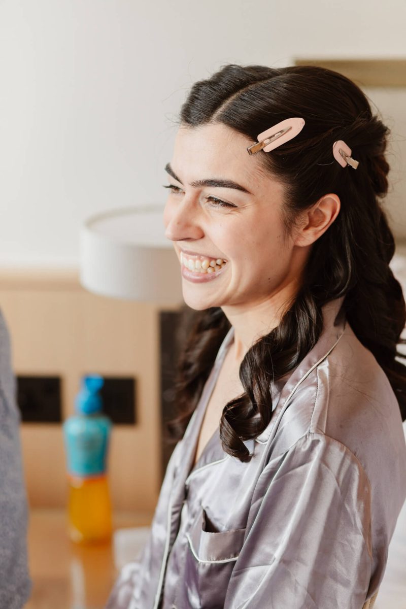 photograph of bride getting ready smiling