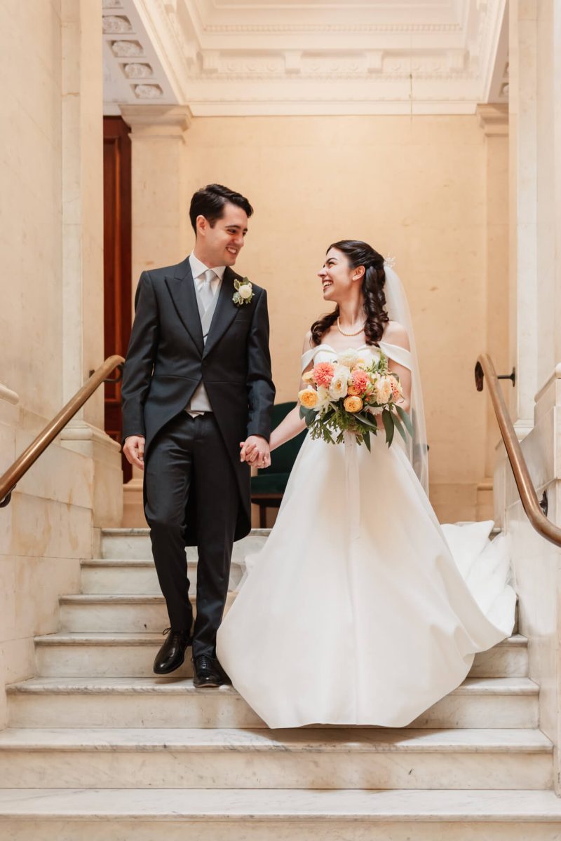 photograph of bride and groom smiling with each other