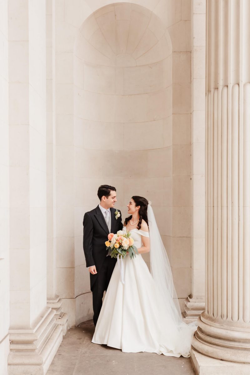 photograph of bride and groom smiling with each other