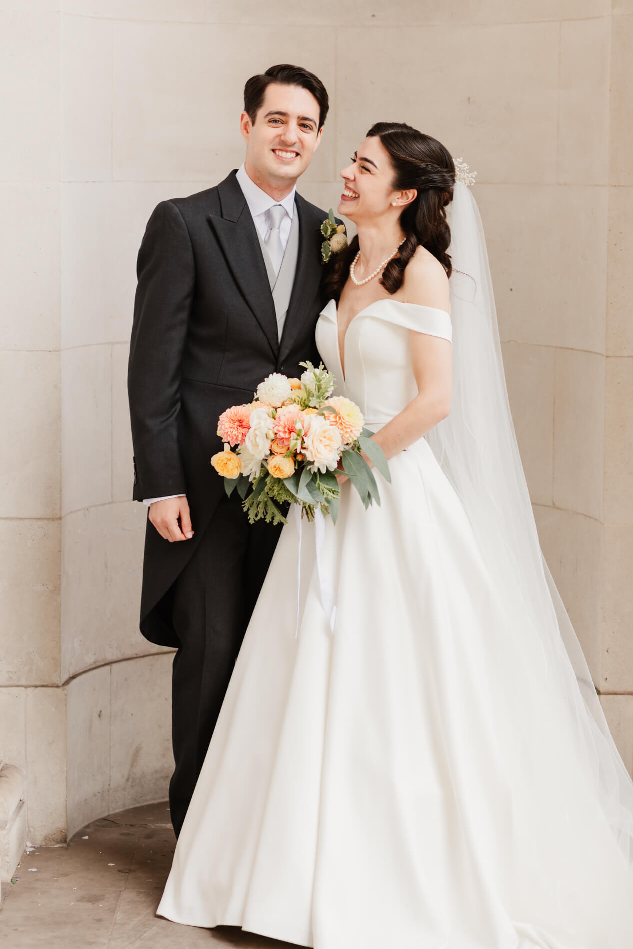 photograph of bride and groom smiling with each other