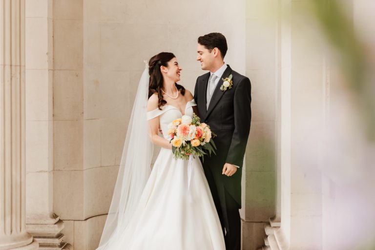 photograph of bride and groom smiling with each other